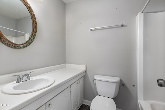 bathroom featuring toilet and vanity