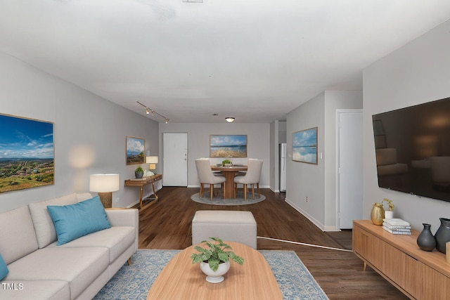 living area with baseboards and dark wood-style flooring