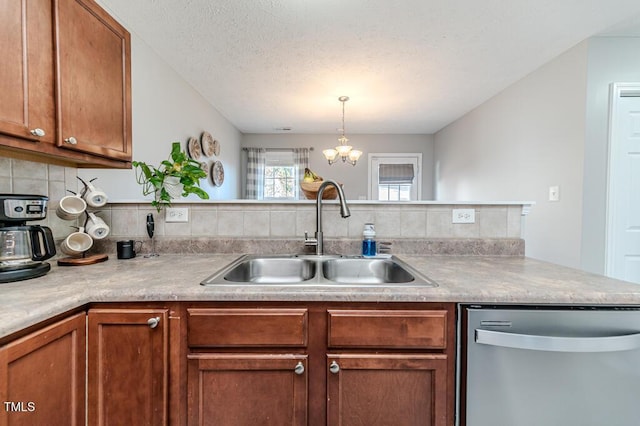 kitchen with stainless steel dishwasher, kitchen peninsula, sink, and a chandelier