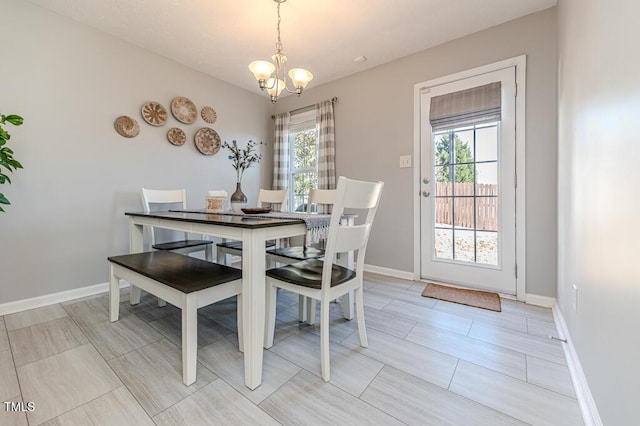 dining space featuring a wealth of natural light and a chandelier