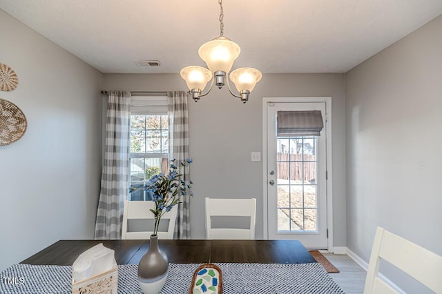 entryway with an inviting chandelier and hardwood / wood-style flooring