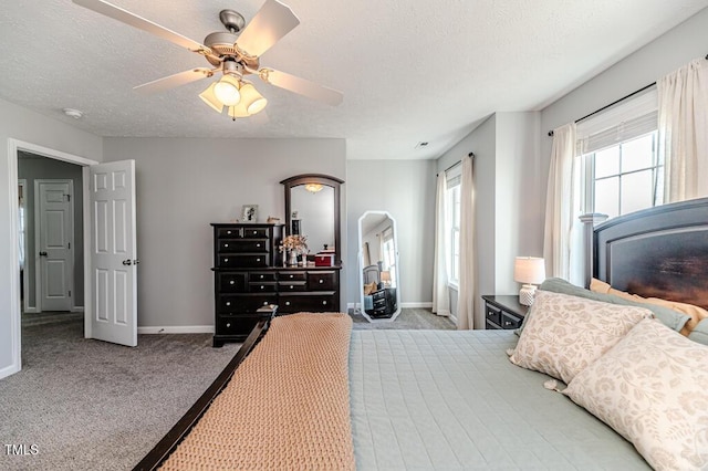 bedroom featuring light carpet, ceiling fan, and a textured ceiling