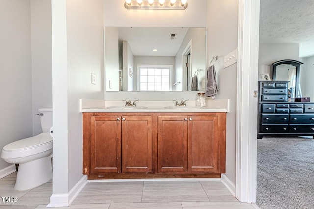 bathroom with toilet and vanity