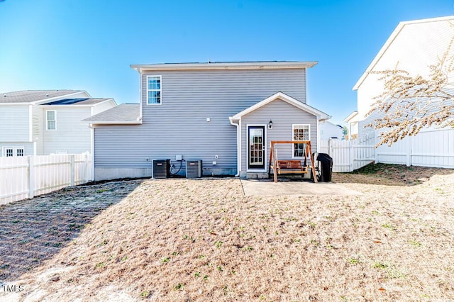 rear view of house with cooling unit and a patio