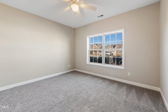 carpeted empty room featuring ceiling fan