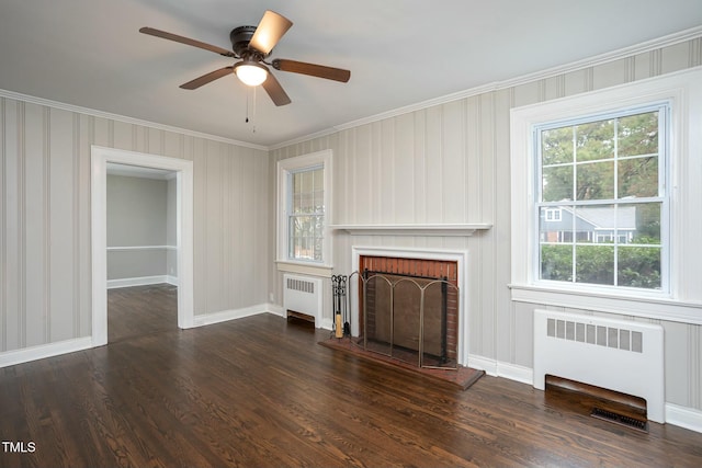 unfurnished living room with baseboards, radiator heating unit, and wood finished floors