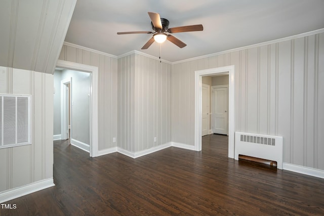 spare room with radiator, visible vents, dark wood-style flooring, and ornamental molding