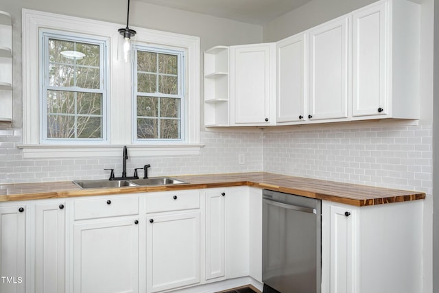 kitchen featuring tasteful backsplash, dishwasher, a sink, open shelves, and wooden counters