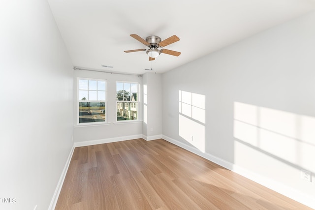 spare room with ceiling fan and light wood-type flooring