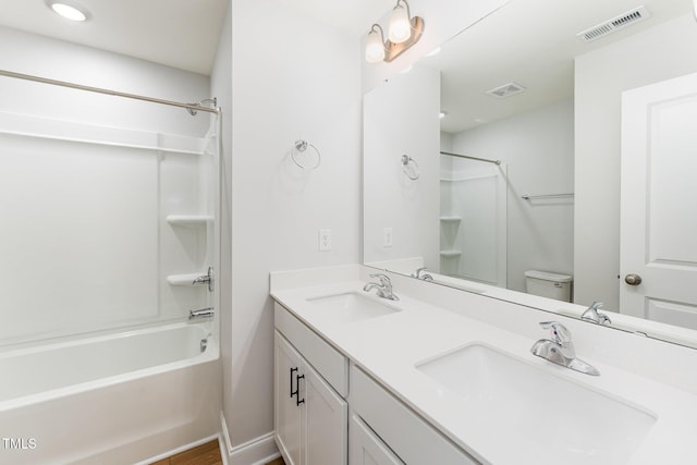 full bathroom with bathtub / shower combination, vanity, and toilet