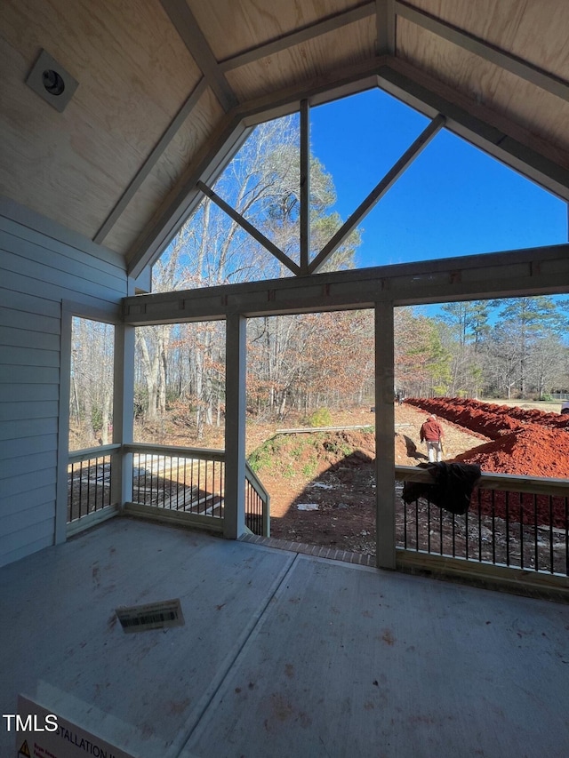 unfurnished sunroom with vaulted ceiling