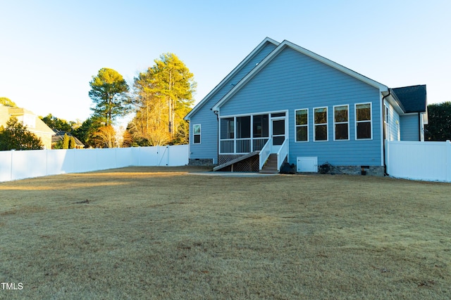 rear view of house with a yard