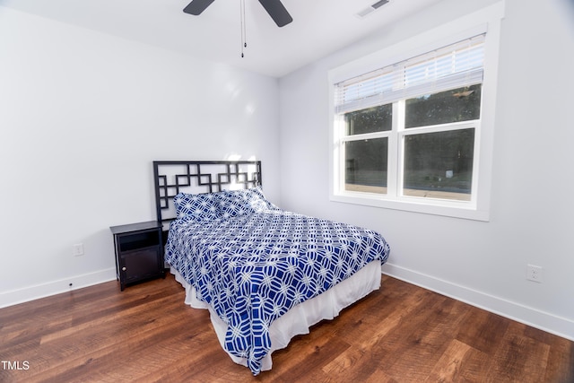 bedroom featuring ceiling fan and dark hardwood / wood-style floors