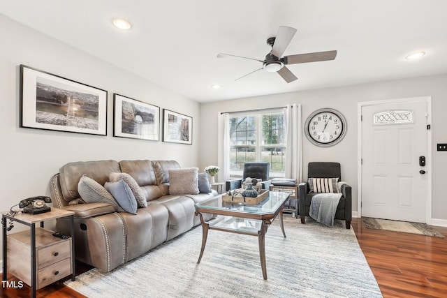 living room featuring hardwood / wood-style flooring and ceiling fan