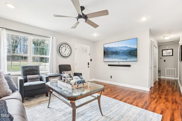 living room with ceiling fan and dark hardwood / wood-style flooring