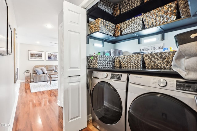 laundry area featuring washer and dryer and hardwood / wood-style floors