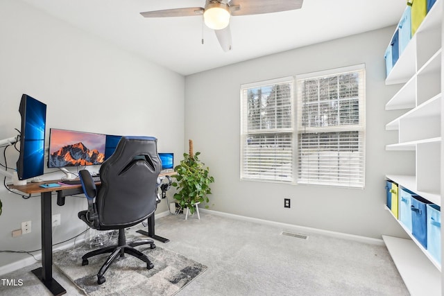 carpeted office featuring ceiling fan