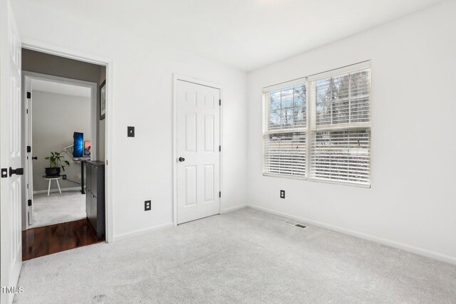 unfurnished bedroom with light carpet