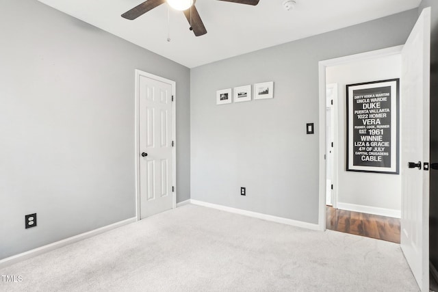 empty room featuring ceiling fan and carpet