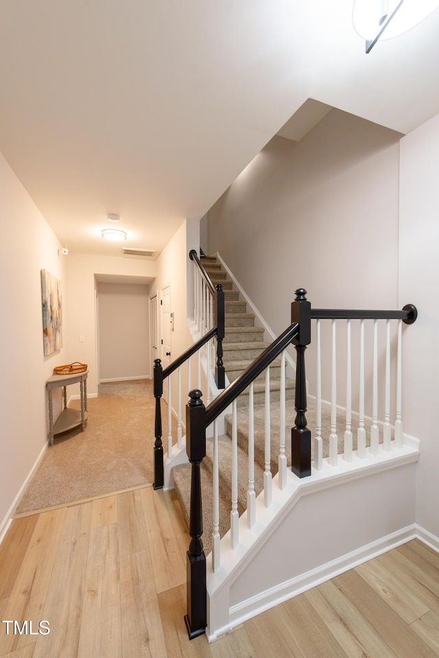 stairway featuring wood-type flooring