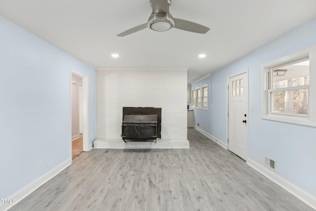 unfurnished living room featuring ceiling fan and light hardwood / wood-style floors