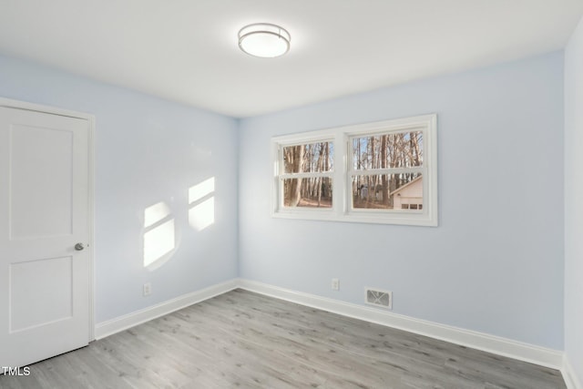 unfurnished room with light hardwood / wood-style floors