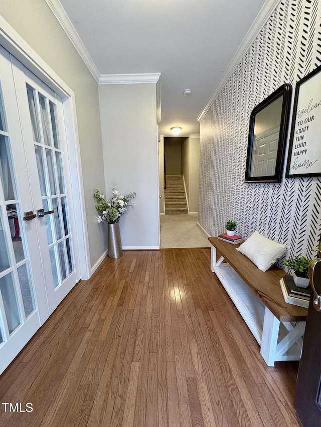 corridor with wood-type flooring, french doors, and crown molding