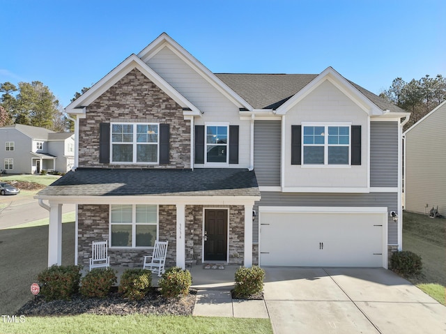 view of front of home featuring a porch and a garage