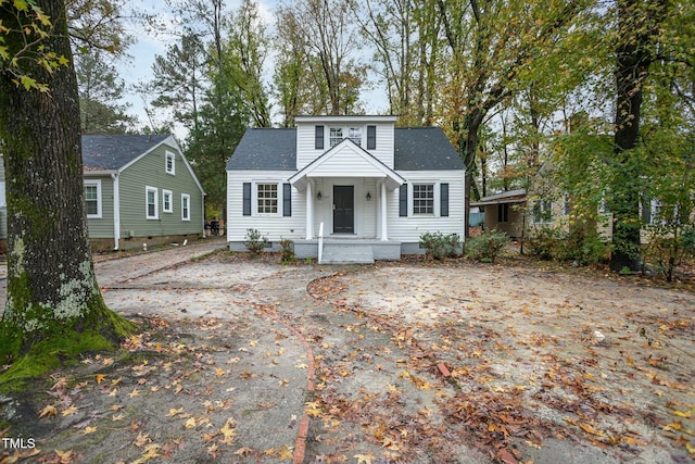 view of front facade with crawl space and roof with shingles