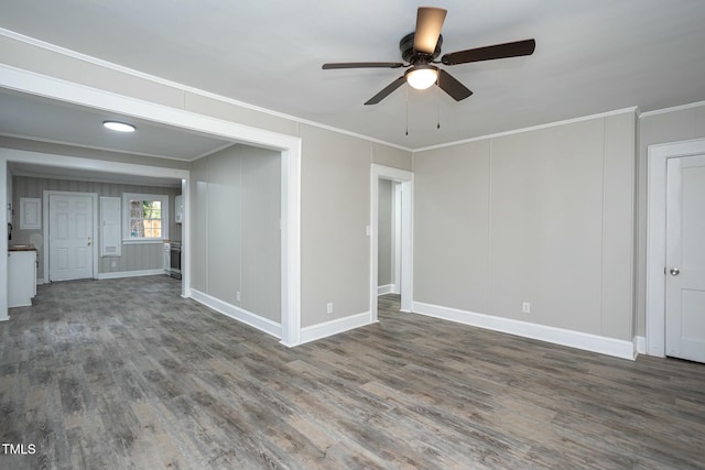 interior space with a ceiling fan, baseboards, ornamental molding, and wood finished floors