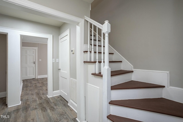 stairs featuring baseboards and wood finished floors