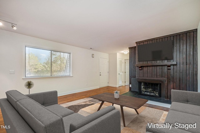 living room with a fireplace and light hardwood / wood-style floors