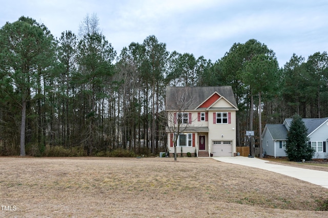 view of front of property with a garage and a front yard