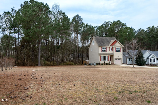 view of front of home featuring a garage and a front lawn