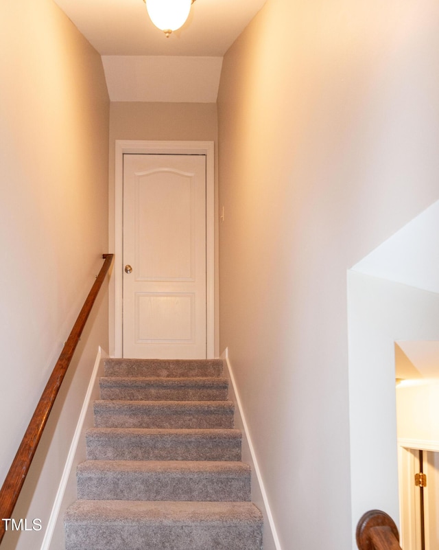 stairs featuring vaulted ceiling