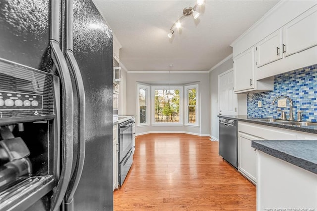 kitchen with stainless steel appliances, white cabinets, decorative backsplash, and sink