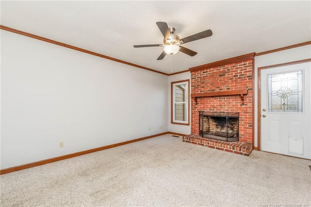 unfurnished living room with a fireplace, ceiling fan, carpet, and crown molding