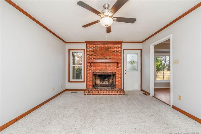 unfurnished living room with a fireplace, light carpet, ceiling fan, and ornamental molding