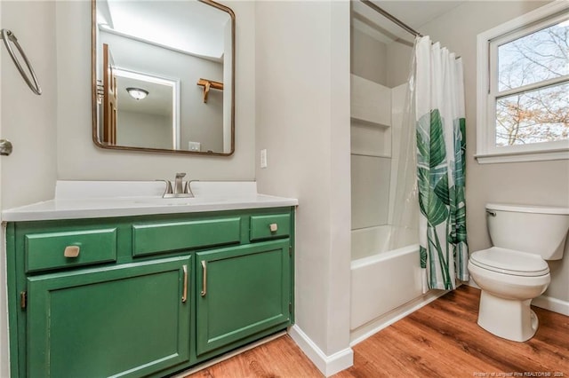 full bathroom featuring toilet, vanity, hardwood / wood-style floors, and shower / tub combo with curtain