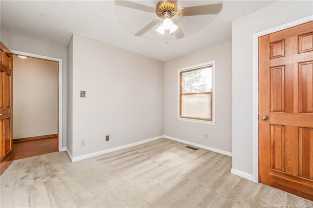 unfurnished bedroom with light carpet and ceiling fan