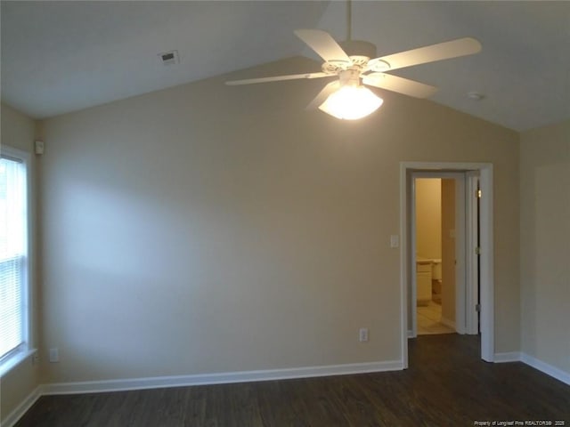 unfurnished room featuring vaulted ceiling, ceiling fan, and dark hardwood / wood-style floors