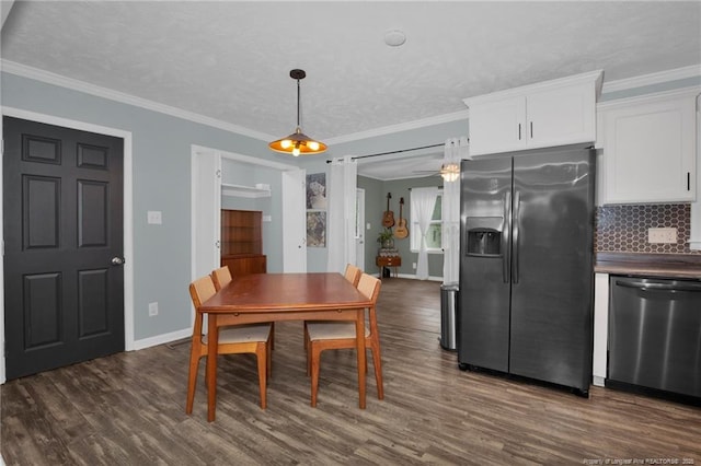 dining room with ceiling fan, dark hardwood / wood-style flooring, ornamental molding, and a textured ceiling