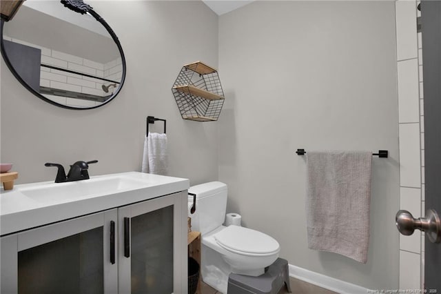 bathroom with toilet and vanity