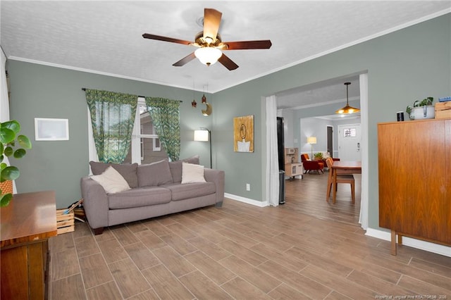 living room with ceiling fan, a textured ceiling, hardwood / wood-style flooring, and ornamental molding