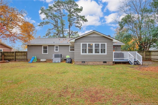 back of property with central air condition unit, a yard, and a wooden deck