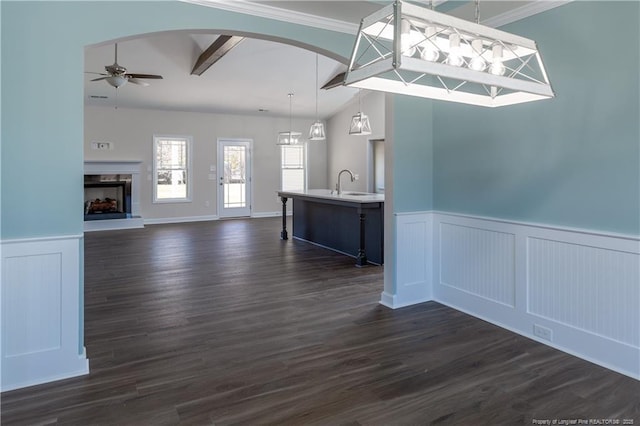 interior space featuring sink, vaulted ceiling with beams, ceiling fan, ornamental molding, and dark hardwood / wood-style floors