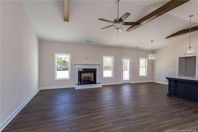 unfurnished living room with dark wood-type flooring, lofted ceiling with beams, and ceiling fan with notable chandelier