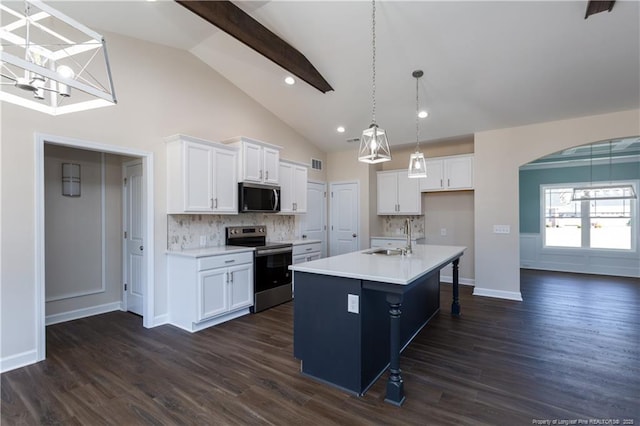 kitchen featuring tasteful backsplash, stainless steel appliances, an island with sink, and white cabinetry