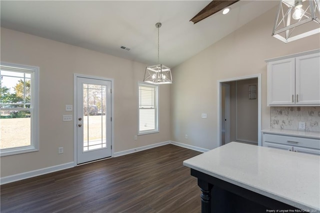 kitchen with decorative light fixtures, white cabinetry, tasteful backsplash, dark hardwood / wood-style flooring, and lofted ceiling with beams