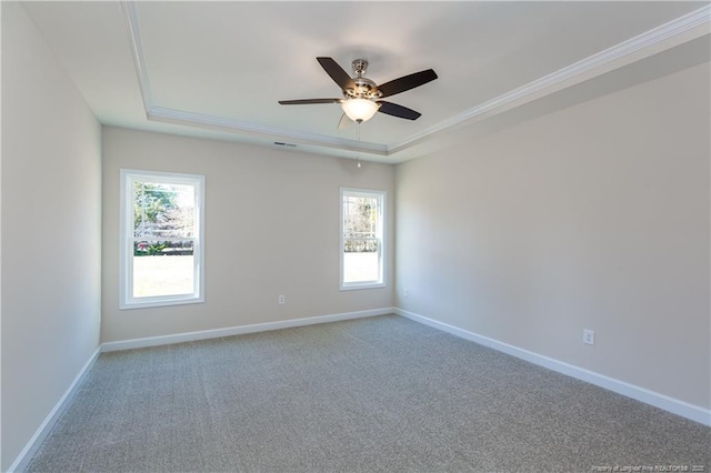 unfurnished room featuring ceiling fan, crown molding, a raised ceiling, and carpet floors